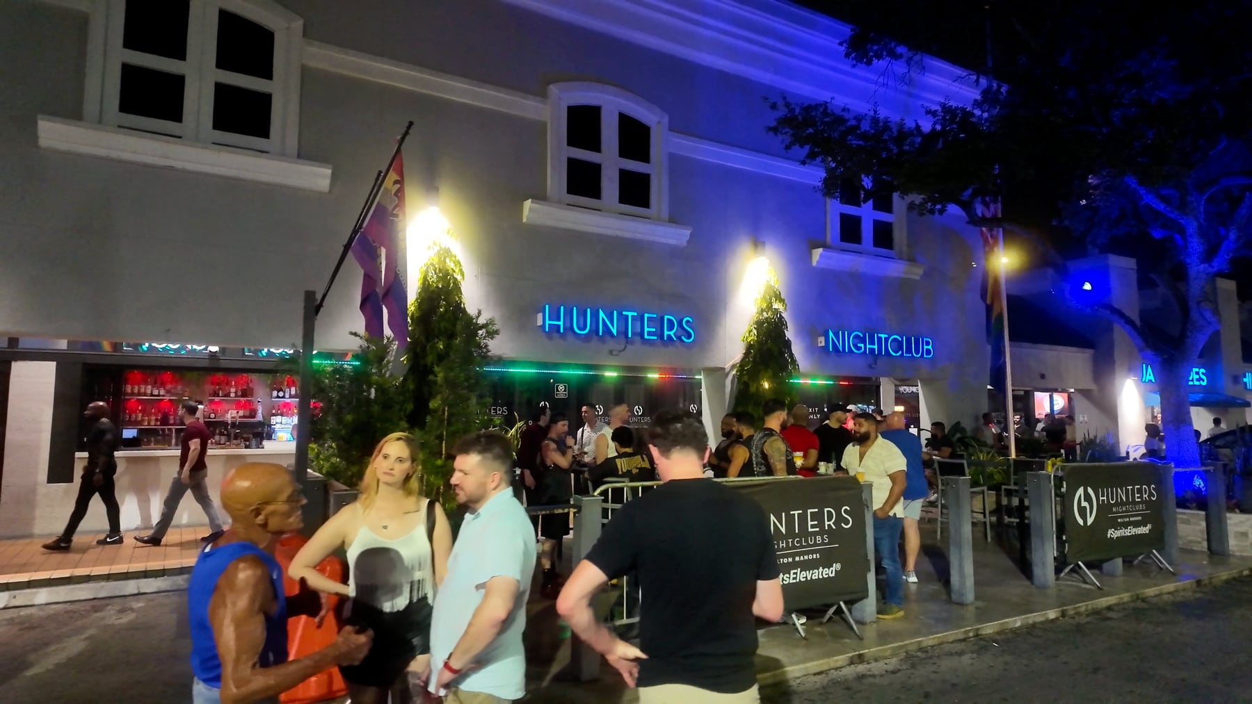 Terraza y letrero de Hunters de noche.